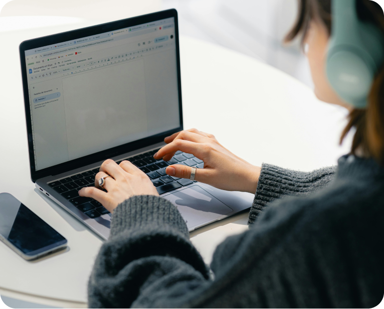 Person typing on a laptop while drafting a digital contract.